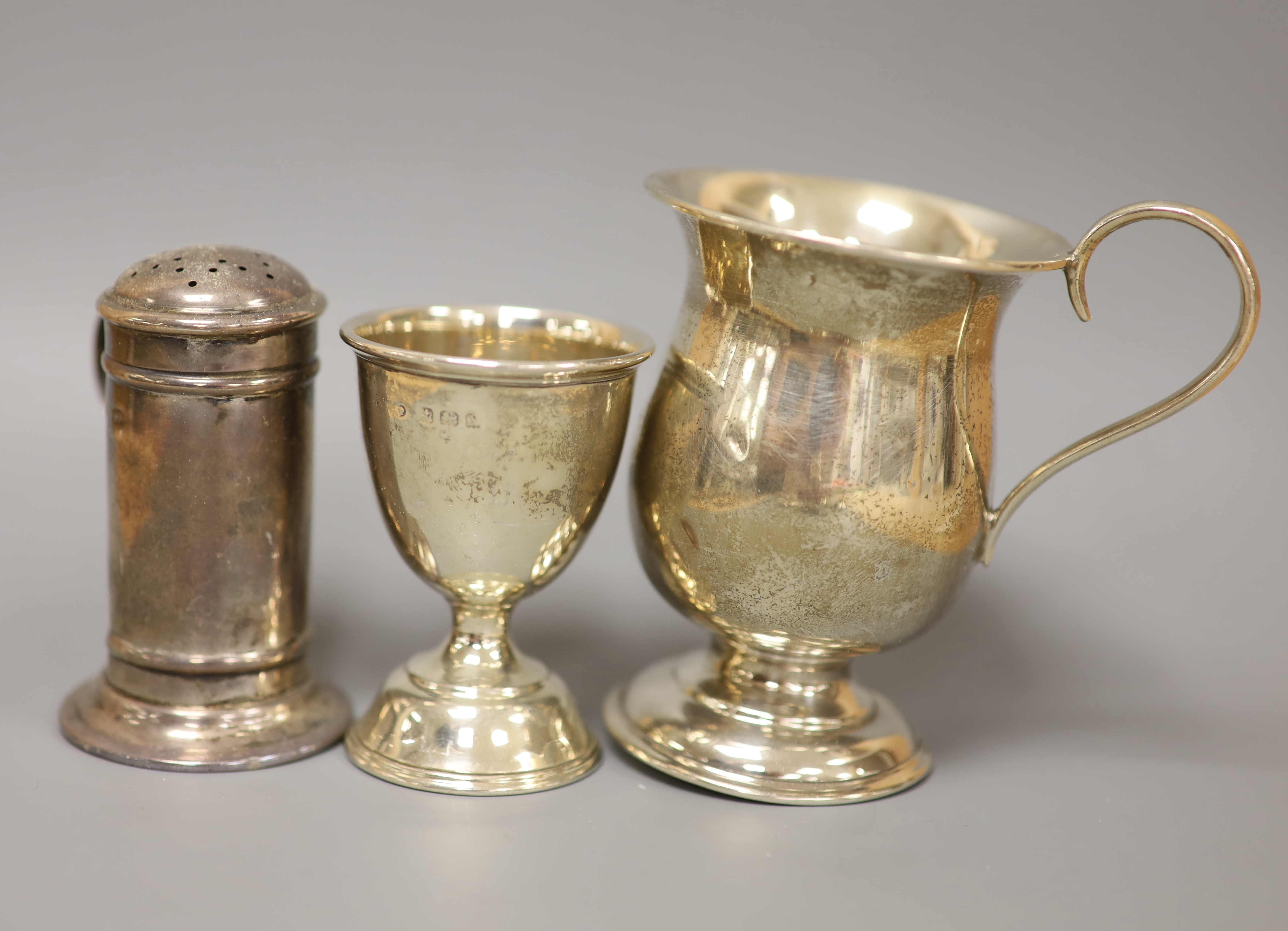 A Victorian silver half-fluted cylindrical vase, a small pedestal cup, a quaich, a Prince of Wales caddy spoon and other silver items